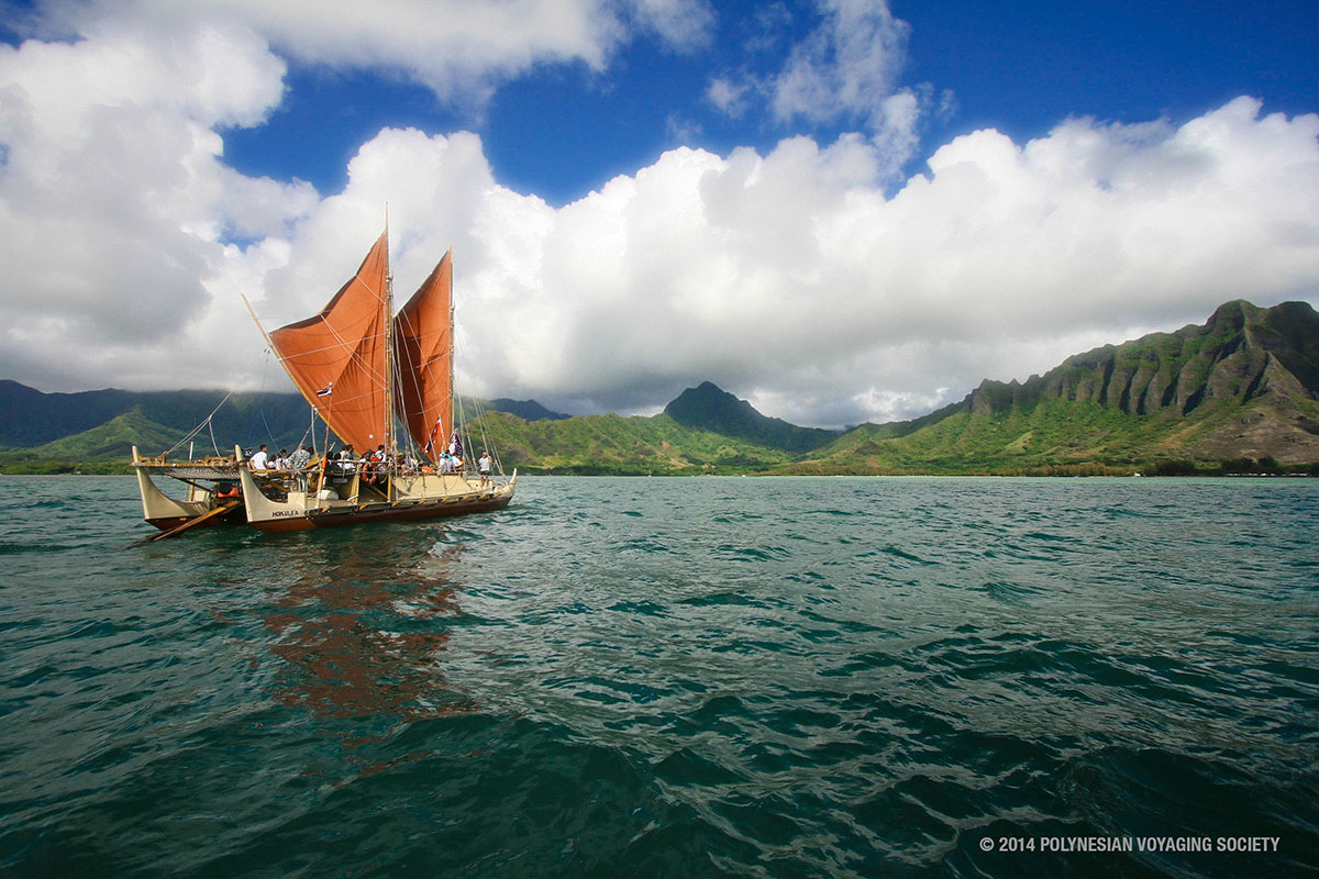 The day breaks over Hōkūleʻa with Kualoa behind her. Photo Courtesy of the Polynesian Voyaging Society.