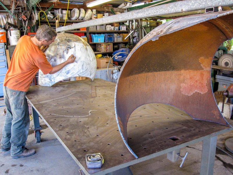 Artist Colin Selig works on a bench that he creates from salvage propane tanks at his workshop in California. For Editorial Use Only.