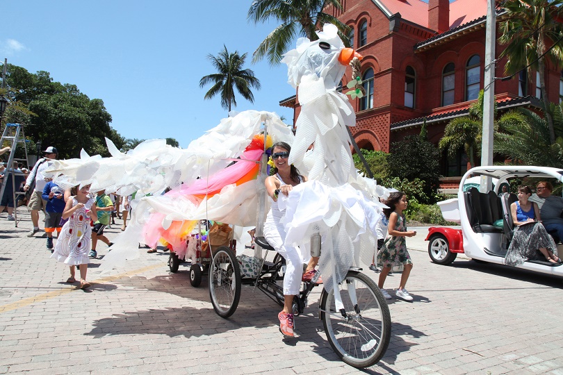 Key West Montessori Charter School Principal Lynn Barras, Ed.M., pilots the “Peace Dove” past the Custom House Museum on Saturday. Crafted of nearly 100% recycled materials and “feathers” made from milk jugs, the fabulous fowl was one of more than thirty kinetic creations that participated in the inaugural Key West Art & Historical Society Stanley Papio Kinetic Sculpture Parade. The zany spectacle of creative whimsy and kinetic savvy was supported in part by a prestigious Knight Arts Challenge People's Choice Award and a Community Foundation of the Florida Keys grant. A permanent exhibit celebrating Papio’s work is now open at Fort East Martello Museum in Key West, and preparations are already underway for next year’s kinetic festivities.  Visit KWAHS.ORG for more information.